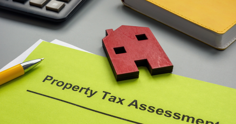 property tax assessment papers and a model of a red house