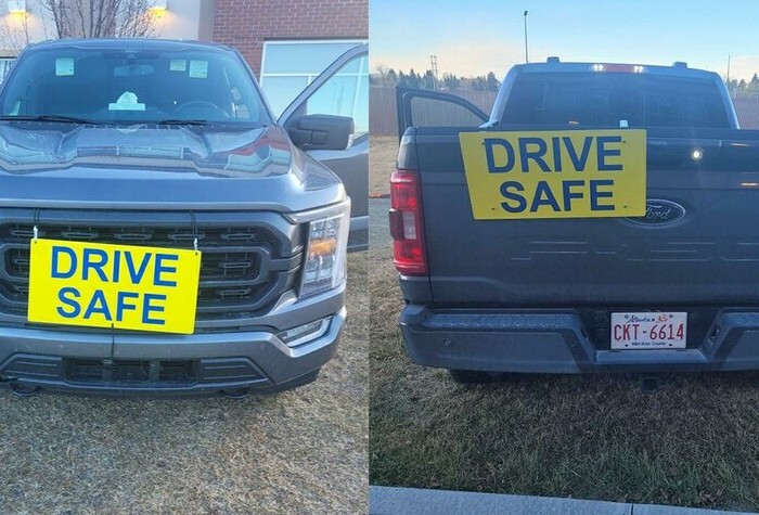 Yellow 'Drive Safe' sign on Pickup truck