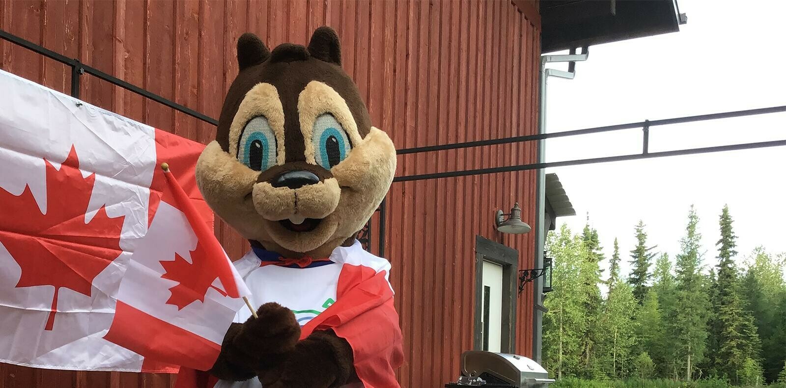 Eddie the Squirrel Mascot holding Canadian Flag